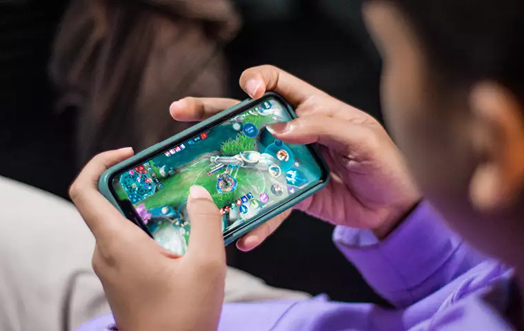 A man is playing a mobile game.
