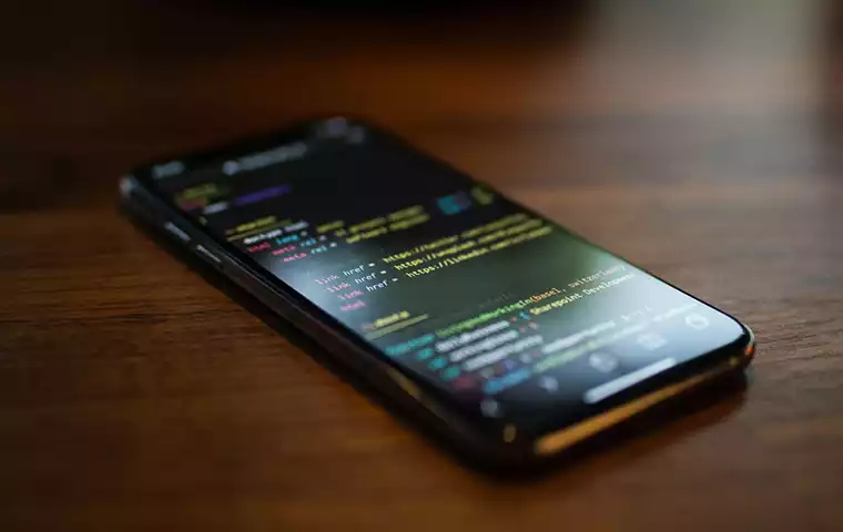 A smartphone with coding on the screen