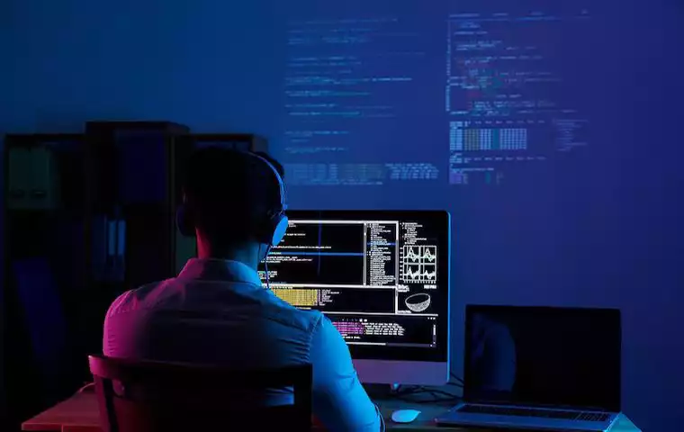 A photo of a developer using a PC for programming